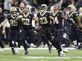 The New Orleans Saints, led by Marcus Lattimore (23), celebrate their victory over the Philadelphia Eagles in the Superdome in New Orleans. (Image: AP)