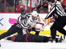 Officials separate Alex Ovechkin from the Washington Capitals after he knocked out Andrei Svechnikov from the Carolina Hurricanes in a fight in the first period of a playoff game in Raleigh, North Carolina. (Image: Getty)