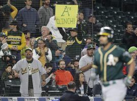 Oakland A's fans celebrate their team advancing to the AL Wild Card for a second consecutive year. (Image: Ted S. Warren/AP)