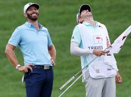 Dustin Johnson and his caddy share a laugh during Sundayâ€™s final round of the Travelers Championship. (Image: Getty)