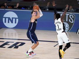 Dallas Mavericks guard Luka Doncic shoots a game-winning shot in overtime over Reggie Jackson of the LA Clippers in Game 4. (Image: Ashley Landis/AP)