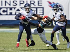 Tennessee Titans RB Derrick Henry stiffarms a Jacksonville Jaguars defender in Week 2. (Image: Getty)