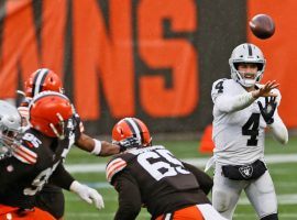 Raiders quarterback Derek Carr stuck with short passes in the wind at Cleveland, as that game was the only one in NFL Week 8 betting that hit the under. (Image: AP)