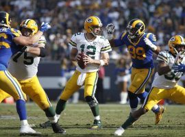 LA Rams DE Aaron Donald closes in on Green Bay Packers QB Aaron Rodgers in 2018. The Packers are favorites by almost a touchdown against the Rams in the NFC Divisional playoff round. (Image: Joe Robbins/Getty)