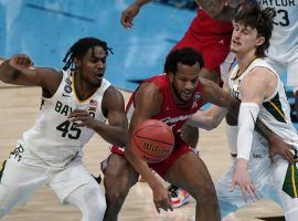 Baylor guards Davion Mitchell (45) and Matthew Mayer (24) swarm Houstonâ€™s Justin Gorman in a Final Four victory. (Image: Michael Conroy/AP)