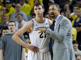 Michiganâ€™s Franz Wagner attentively listens to advice from head coach Juwan Howard during a game against Indiana in 2020. (Image: Rick Osentoski/USA Today Sports)