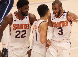 Deandre Ayton (22), Devin Booker (1), and Chris Paul (3) of the Phoenix Suns are the favorites heading into Game 1 of the 2021 NBA Finals against the Milwaukee Bucks. (Image: Matt York/AP)