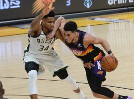 Devin Booker from the Phoenix Suns accelerates by Giannis 'Greek Freak' Antetokounmpo from the Milwaukee Bucks in a Game 2 victory in the 2021 NBA Finals at Phoenix Suns Arena. (Image: Peter Carini/Getty)