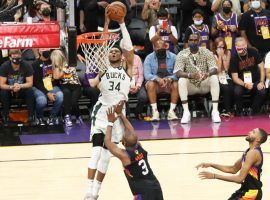 Giannis â€˜Greek Freakâ€™ Antetokounmpo of the Milwaukee Bucks completes an alley-oop dunk over Chris Paul from the Phoenix Suns to seal Game 5 of the NBA Finals. (Image: Porter Lambert/Getty)