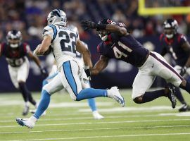 Christian McCaffrey from the Carolina Panthers evades a tackler from the Houston Texans and suffered a hamstring injury on the play. (Image: Tim Warner/Getty)