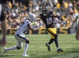 Pittsburgh Steelers wide receiver Diontae Johnson stiffarms a defender from the Las Vegas Raiders. (Image: Matt Durisko/Getty)