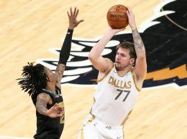 Dallas Mavericks star Luka Doncic (77) shoots a 3-pointer over Ja Morant from the Memphis Grizzlies. (Image: Nelson Chenault/USA Today Sports)