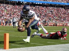 Seattle Seahawks quarterback Russell Wilson dives into the end zone for a touchdown against the San Francisco 49ers. (Image: Tony Avelar/AP)