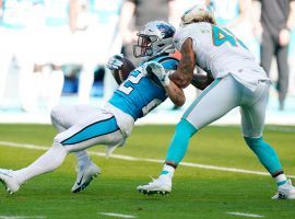 Duke Riley from the Miami Dolphins tackles Christian McCaffrey of the Carolina Panthers before he exited the game with an ankle injury. (Image: Wilfredo Lee/AP)