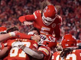 The Kansas City Chiefs mob tight end Travis Kelce after catching a touchdown in overtime to defeat the Buffalo Bills in overtime in the AFC Divisional Round in one of the greatest playoff games in NFL history. (Image: USA Today Sports)