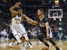 Giannis â€˜Greek Freakâ€™ Antetokounmpo from the Milwaukee Bucks defends Steph Curry from the Golden State Warriors. (Image: Benny Sieu/USA Today Sports)