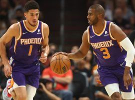 Chris Paul from the Phoenix Suns bring the ball up the court with Devin Booker trailing. (Image: Donald Becker/Getty)