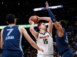 The Memphis Grizzlies swarm Denver Nuggets big man Nikola Jokic at The Ball Arena. (Image: Porter Lambert/Getty)