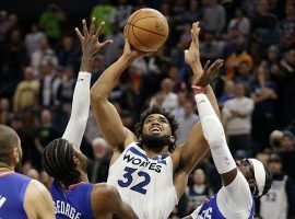 Karl-Anthony Towns from the Minnesota Timberwolves shoots in traffic over Paul George from the LA Clippers. (Image: Andy Clayton-King/AP)