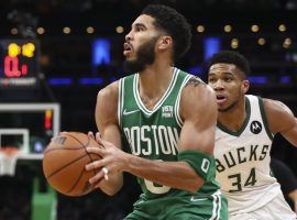 Jayson Tatum from the Boston Celtics pulls up for a jump shot against Giannis â€˜Greek Freakâ€™ Antetokounmpo from the Milwaukee Bucks. (Image: Getty)