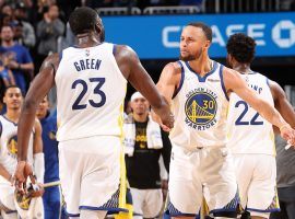 Steph Curry congratulates Draymond Green after the Golden State Warriors defeat the Memphis Grizzlies in Game 4 to take a 3-1 series lead in the Western Conference Semifinals. (Image: Joe Murphy/Getty)