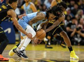 Jordan Poole from the Golden State Warriors grabs the knee of Ja Morant from the Memphis Grizzlies in Game 3 at Chase Center in San Francisco. (Image: Getty)