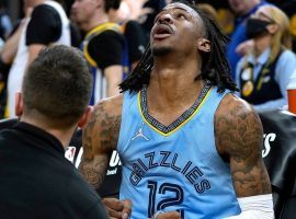 Ja Morant from the Memphis Grizzlies gets his knee injury checked out by medical staff during the fourth quarter of Game 3 against the Golden State Warriors. (Image: Getty)